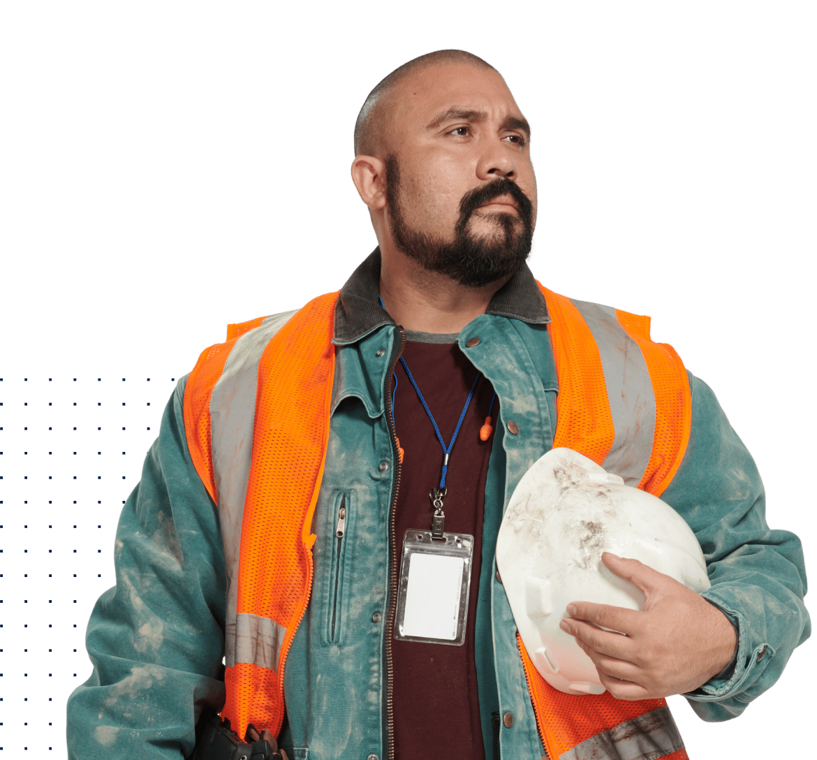 Man in construction PPE vest holding helmet and looking off confidently