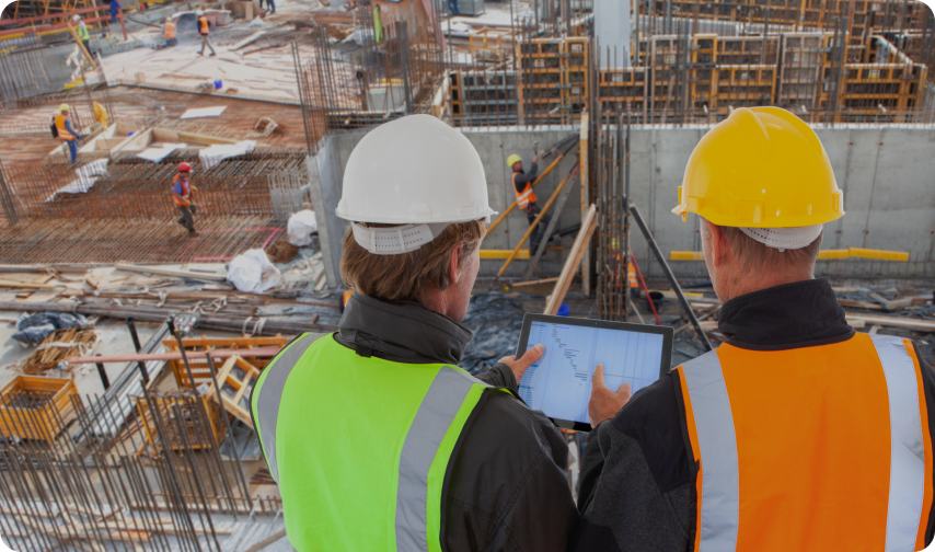 Construction workers use Bluebeam construction management tools while overlooking the jobsite