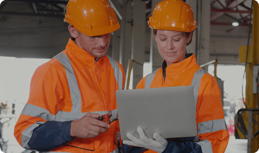 Two constructors looking at laptop