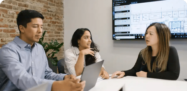 Three people in a conference room working on a PDF in Revu