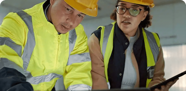 Two construction workers wearing safety gear